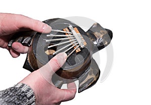 Man's hands with colorful musical instrument Kalimba. Close-up. Isolated on white background. Tsantsa, Sanza, Mbira, Mbila, Ndimb