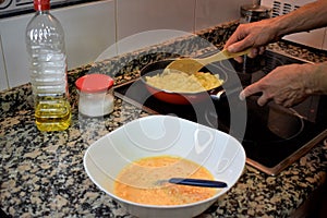 Man`s hands cooking spanish omelette photo