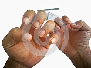 Man`s hands with dirty nail using nail clipper for fingernails manicure isolated on white background