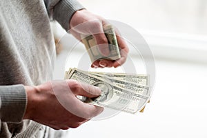 Man`s hands with dollars on white background. man gives a bribe . corruption background