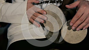 Man`s hands drumming out a beat on an arabic percussion drum named Kasoureh