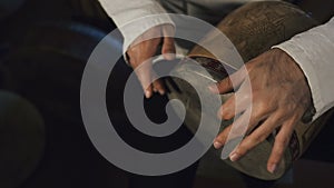 Man`s hands drumming out a beat on an arabic percussion drum named Tombak