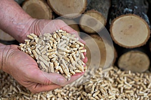 Man`s hands full of wood pellets - renewable energy