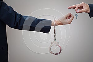 Man's hands in handcuffs and key