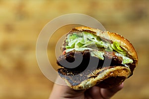 Man`s hands, holding onto a burger