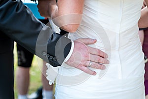 Man's hands hugging female booty, close-up