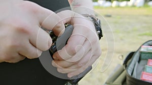 Man`s hands loading a pistol magazine. man loads the clip of pistol.