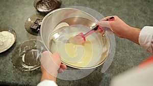 Man's hands mixing liquid batter for crepes or cake