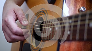Man's Hands Playing Acoustic Guitar