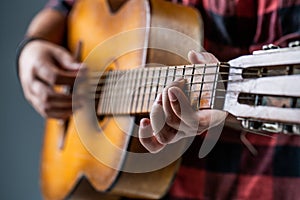 Man`s hands playing acoustic guitar, close up. Acoustic guitars playing. Music concept. Guitars acoustic. Live music