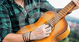 Man's hands playing acoustic guitar, close up. Acoustic guitars playing. Music concept. Guitars acoustic. Live music