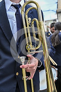 Man& x27;s hands playing the trombone in the orchestra