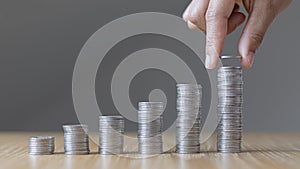 Man`s hands put the coins arranged in steps, Managing your finances or saving money for future use, Saving for investment