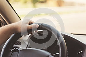 man's hands on the steering wheel retro toning car