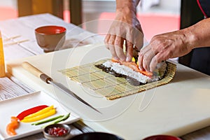 Man's hands touch bamboo mat.