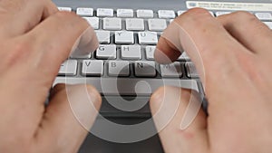 Man`s hands typing on a keyboard