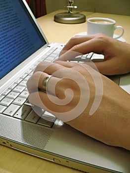 Man's Hands Typing at laptop