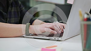 A Man`s Hands Typing on the Laptop Indoors