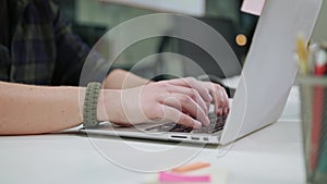 A Man`s Hands Typing on the Laptop Indoors