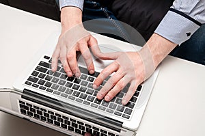 Man's hands typing on laptop. Internet surfing