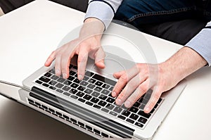 Man's hands typing on laptop. Internet surfing