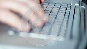 Man`s hands typing on laptop keyboard