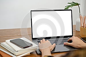 A man`s hands are typing on a laptop keyboard, using a laptop. notebook laptop white screen mockup