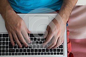 Man`s hands typing on laptop notebook keyboard at home. Man browsing information on internet. Freelance blogging, it