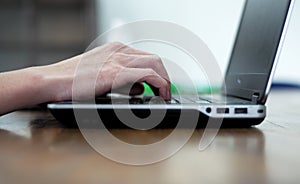 Man`s hands typing the notebook keyboard