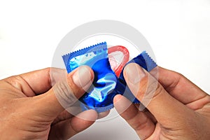 Man's Hands Unwrapping a Condom