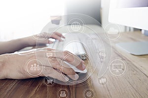 Man`s hands using computer with social connect icons