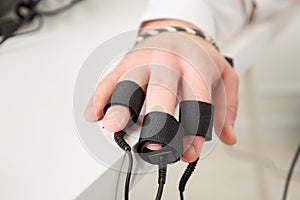 Man`s hands on which polygraph sensors are worn