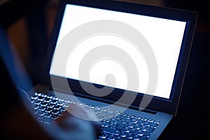 Man`s hands working on the laptop at night