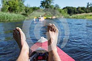 Man's legs over canoe.