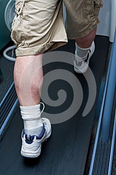 Man's legs walking on treadmill