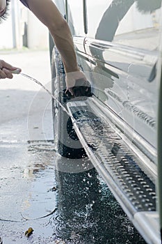 Man `s washing car by himself at home