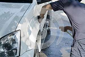 Man `s washing car by himself at home