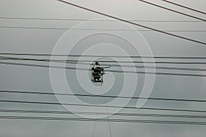 A man safely working an extremely dangerous job inspecting high-voltage power lines