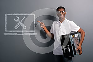 Man in safety glasses holding computer