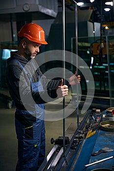 Man in a safety helmet works with a spacer