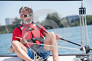 man sailing boat on lake