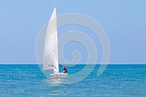 Man sailing. Boy learning to sail on sea yacht