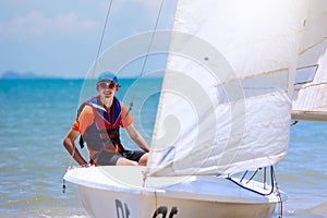 Man sailing. Boy learning to sail on sea yacht