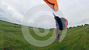 A man sailplanes a glider in sky.