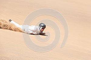 Man sandboarding in Swakopmund