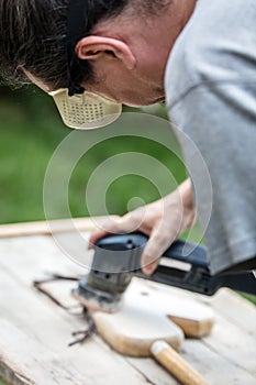 Man is sanding an old hobbyhorse