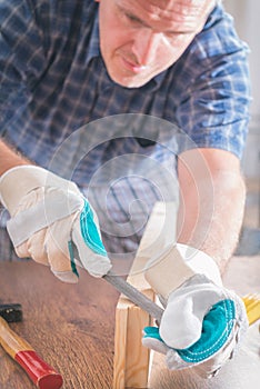 Man sanding a wood in a workshop