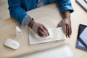 Man Sanitizing Keyboard at Wokplace photo