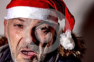 man with Santa Claus hat making a face in the foreground, Christmas is coming.