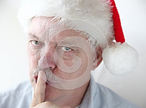 Man in Santa hat asks for quiet